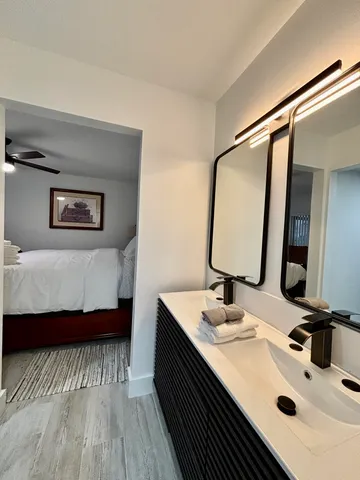 a en suite bathroom with a double vanity sink and a mirror