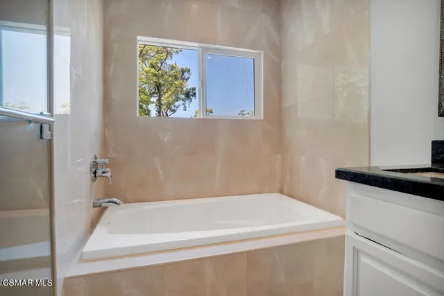 a bathroom with a bathtub and a shower