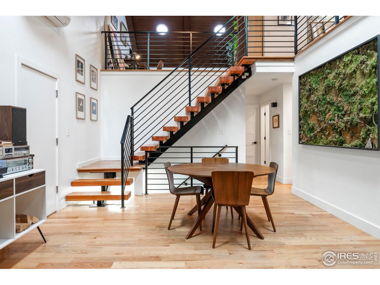 2589 Alkire Street Golden, CO 80401 - Photo 16 of 50 a dining room with wooden floor table and chairs