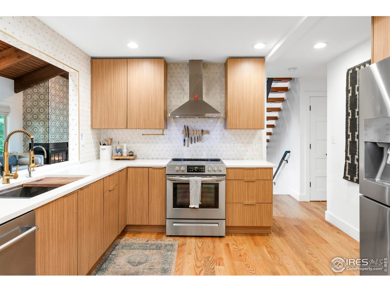 2589 Alkire Street Golden, CO 80401 - Photo 20 of 50 a kitchen with stainless steel appliances granite countertop a stove a sink and a refrigerator