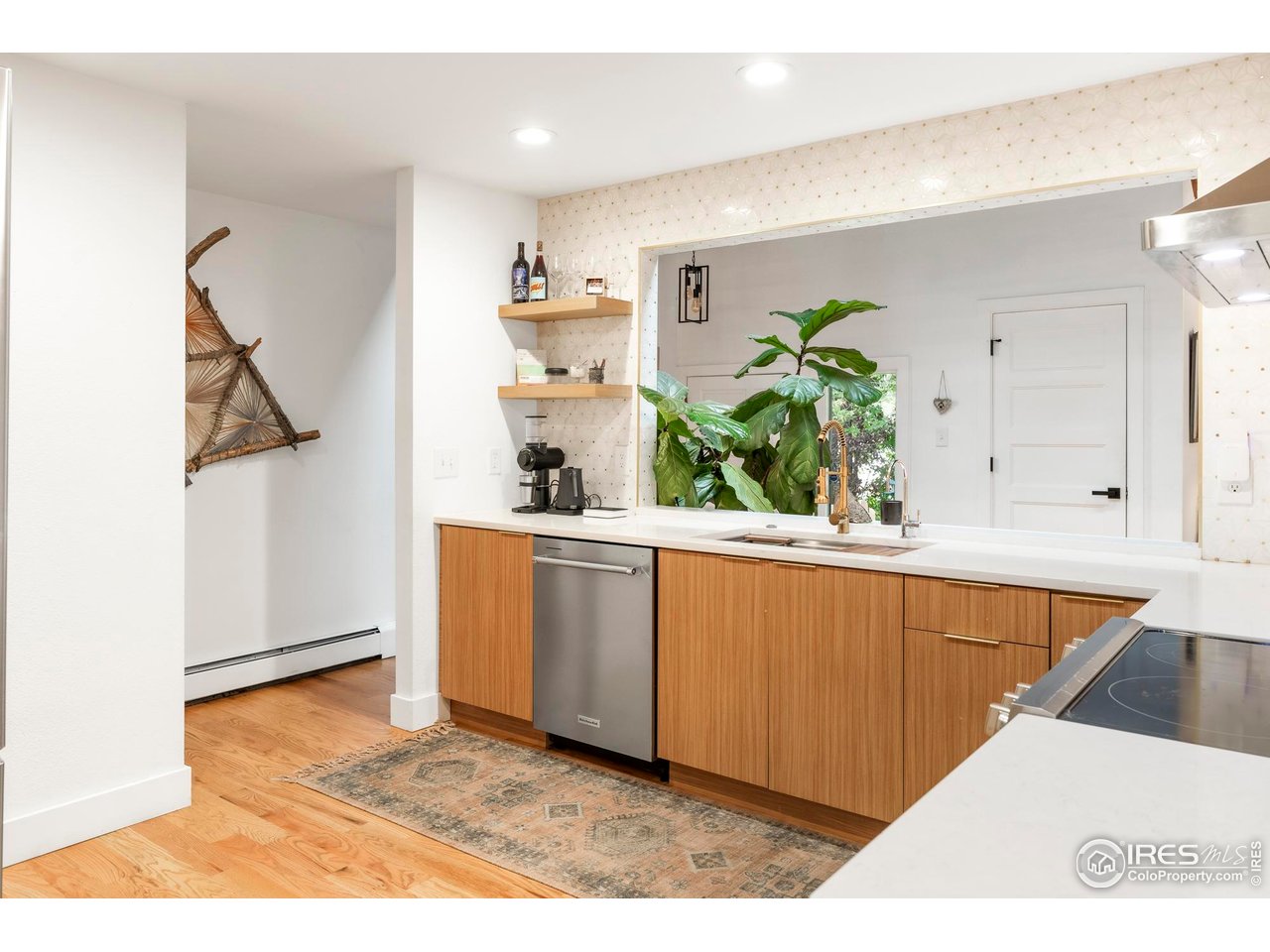2589 Alkire Street Golden, CO 80401 - Photo 22 of 50 a kitchen with stainless steel appliances kitchen island granite countertop a refrigerator and a sink