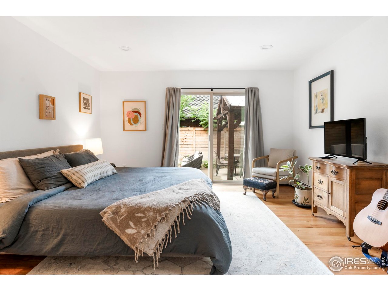 2589 Alkire Street Golden, CO 80401 - Photo 24 of 50 a bedroom with a bed and a flat screen tv