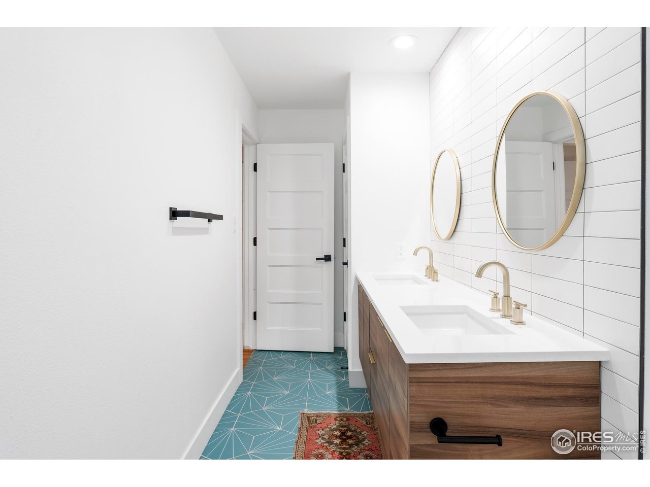 2589 Alkire Street Golden, CO 80401 - Photo 25 of 50 a bathroom with a sink a mirror and a shower