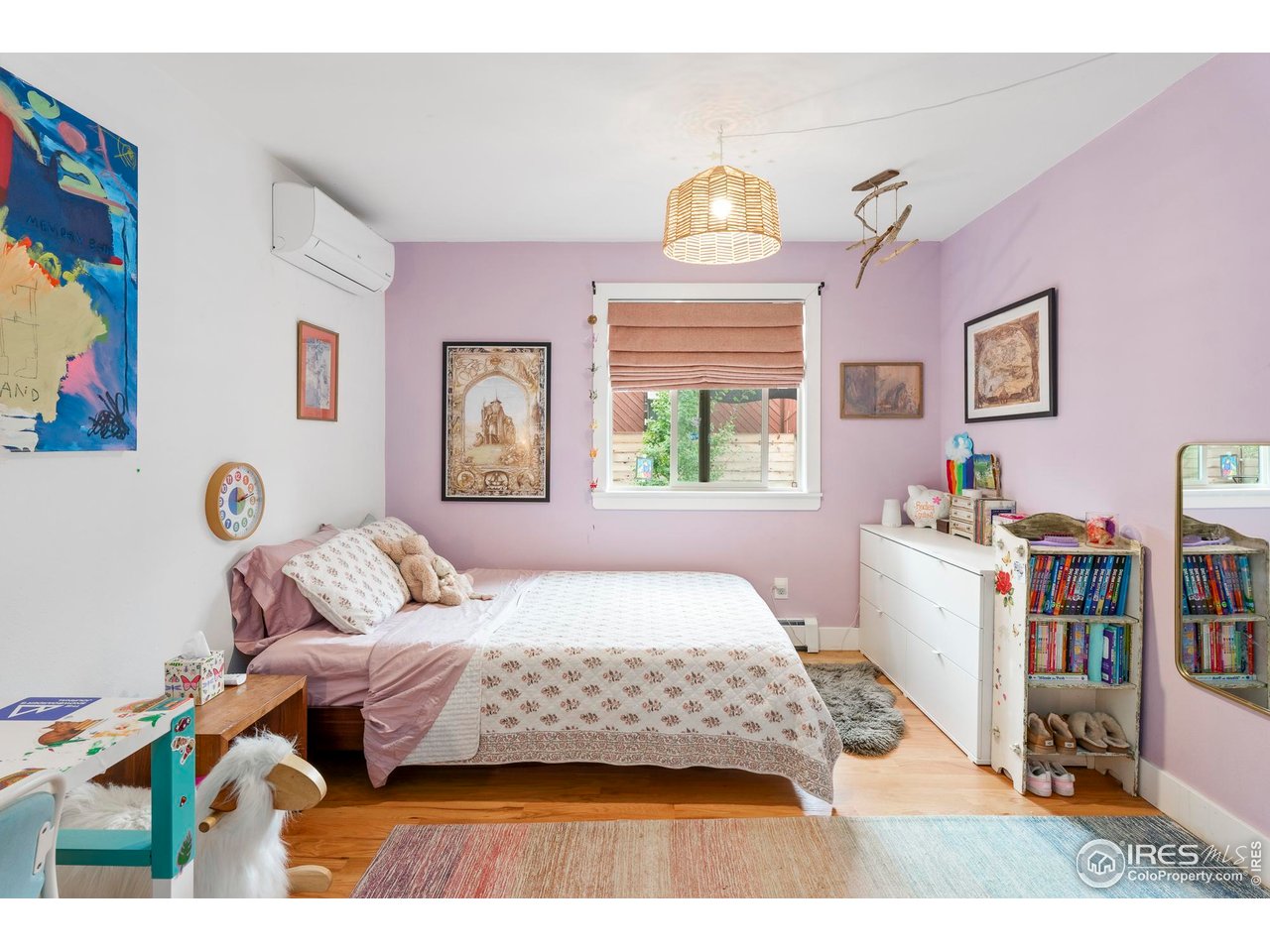 2589 Alkire Street Golden, CO 80401 - Photo 27 of 50 a bedroom with a bed and wooden floor
