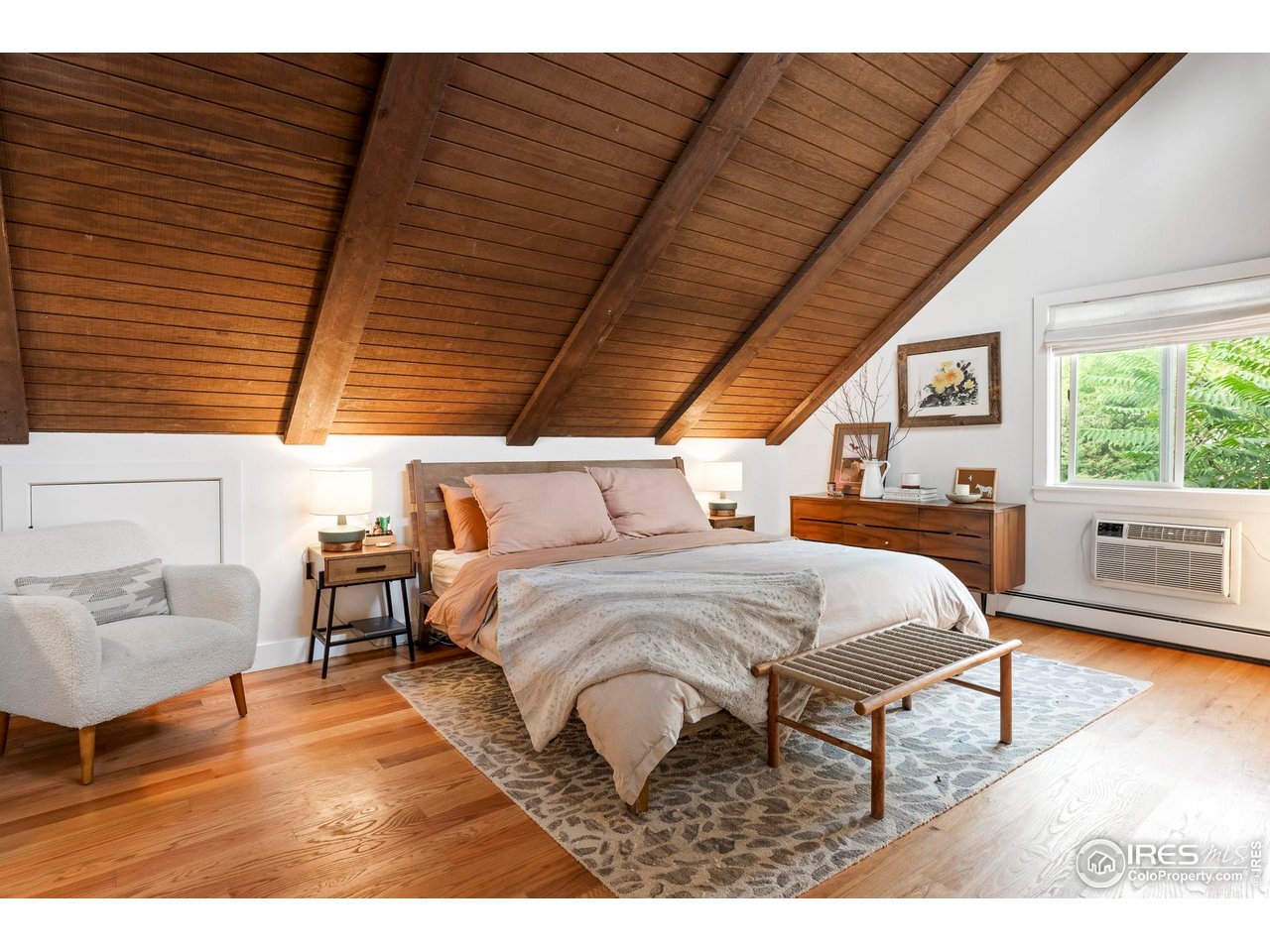 2589 Alkire Street Golden, CO 80401 - Photo 38 of 50 a spacious bedroom with a bed a couch and a window