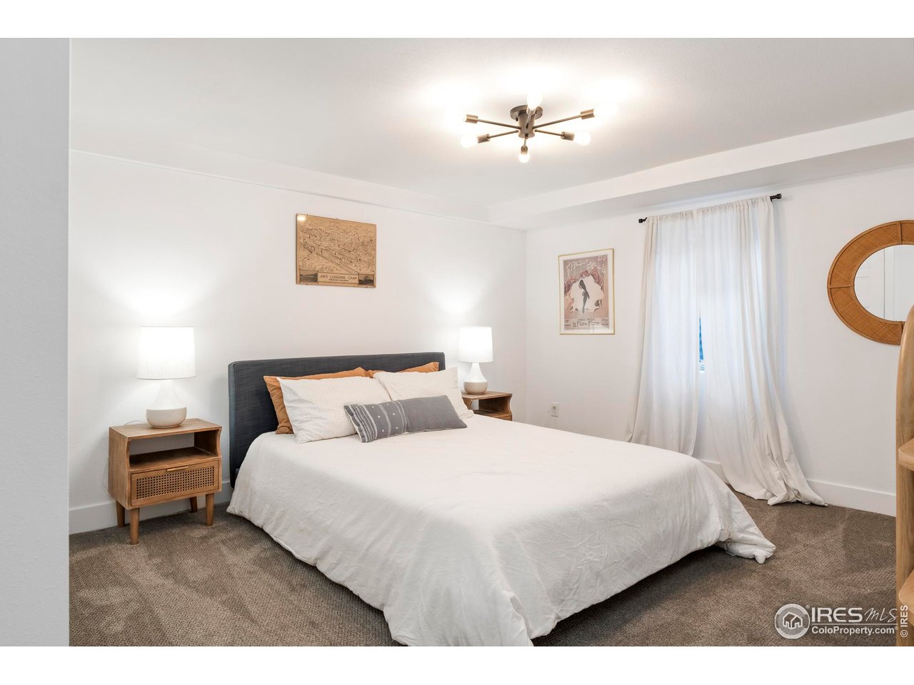 2589 Alkire Street Golden, CO 80401 - Photo 43 of 50 a bedroom with a bed and a chandelier