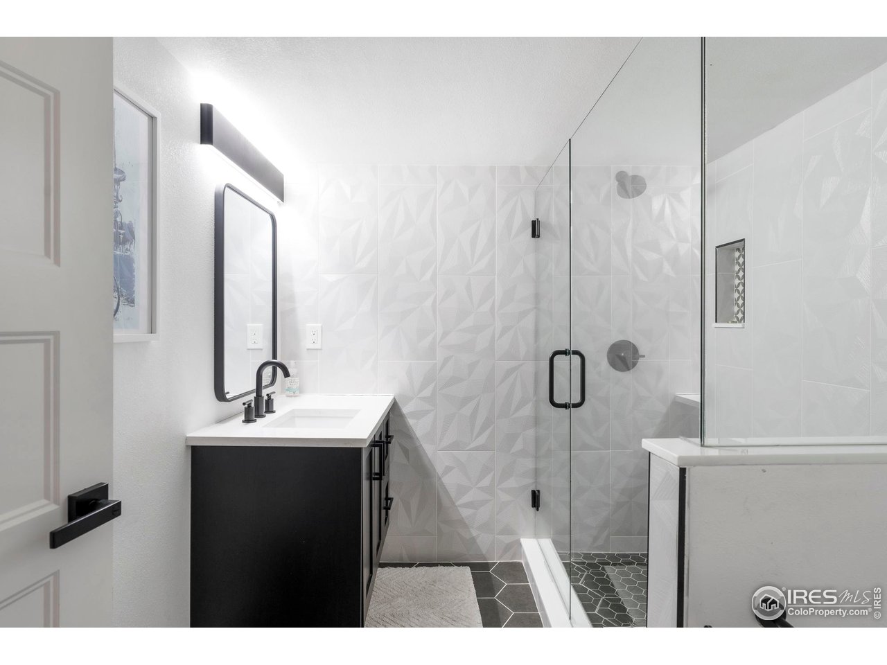 2589 Alkire Street Golden, CO 80401 - Photo 44 of 50 a bathroom with a sink a mirror and shower