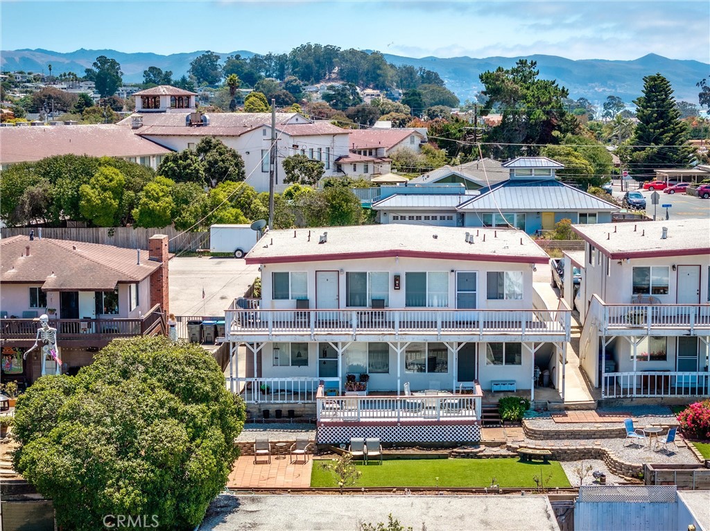 375 Surf Street Morro Bay, CA 93442 - Photo 1 of 25 a front view of a building with a garden and lake view
