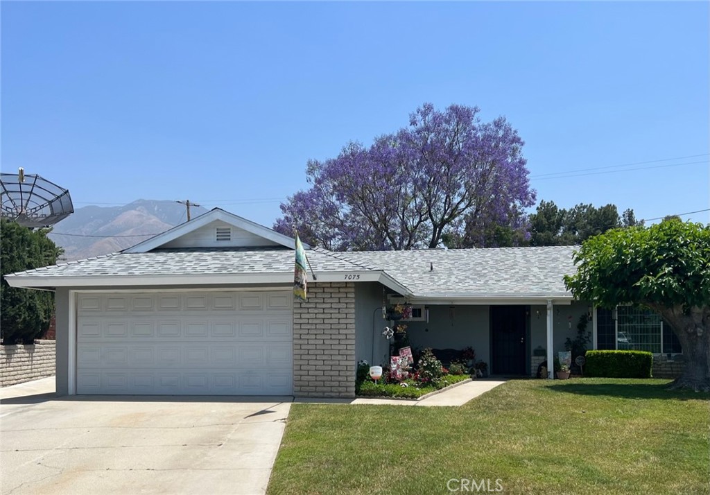 a view of a house with a yard and sitting area