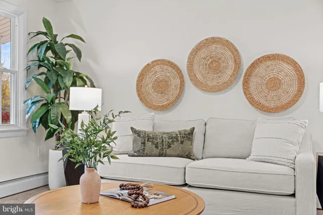 a vase of flowers sitting on a table with a fireplace