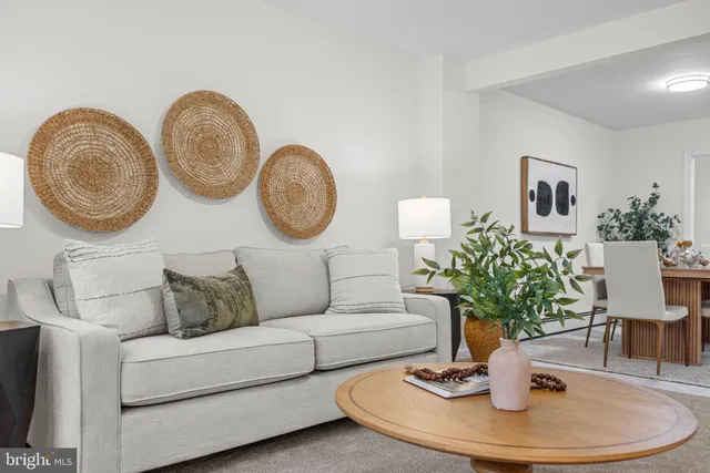 a kitchen with stainless steel appliances granite countertop a refrigerator a sink a stove a dining table and chairs