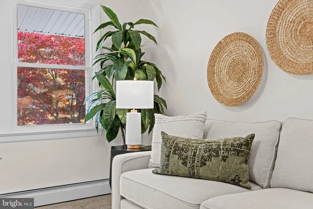 a view of living room with furniture and wooden floor
