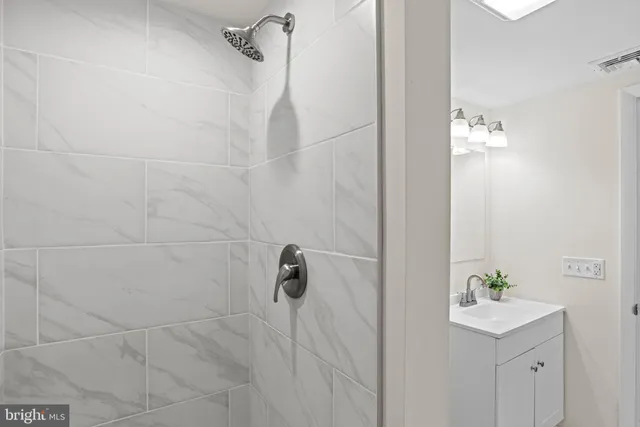 a living room with furniture and a painting on the wall