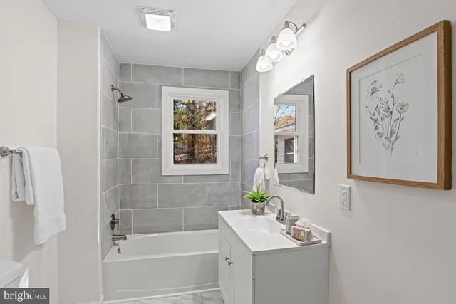 a living room with furniture and a dining table with kitchen view