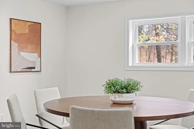 a dining room with furniture and window