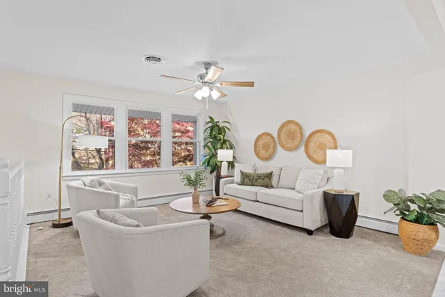 a living room with furniture and a dining table