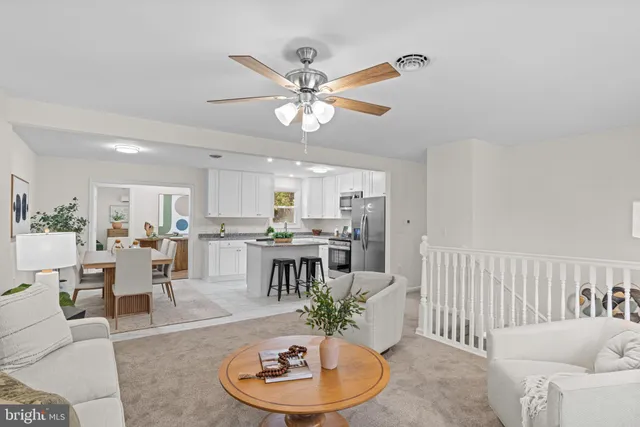 a living room with a bed and a window