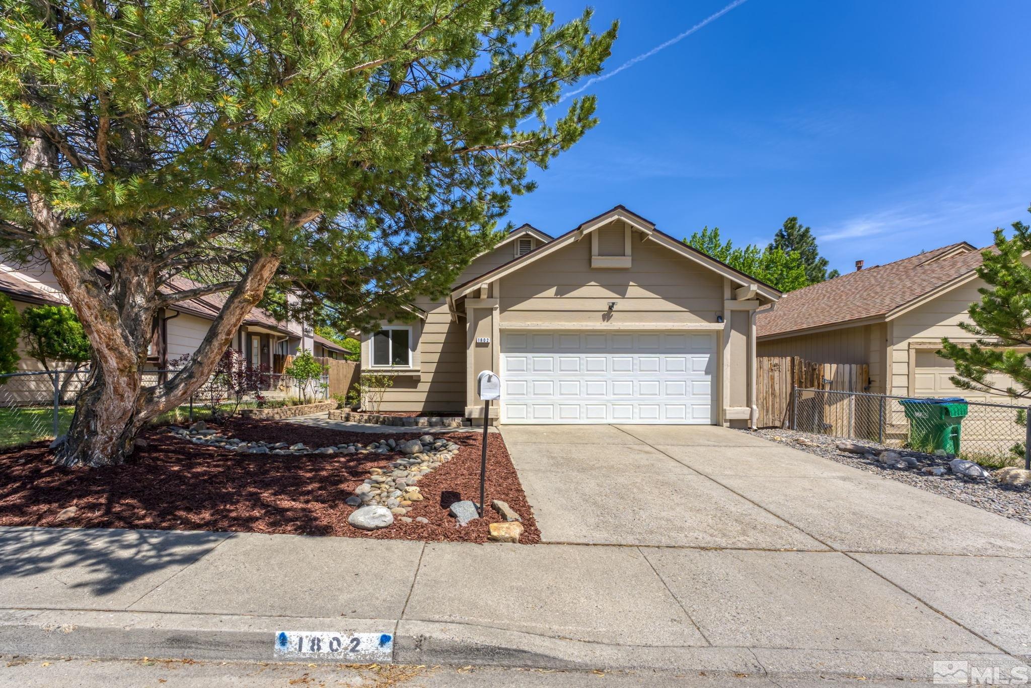 1802 Grand Point Way Reno, NV 89523 - Photo 1 of 19 a front view of a house with a yard