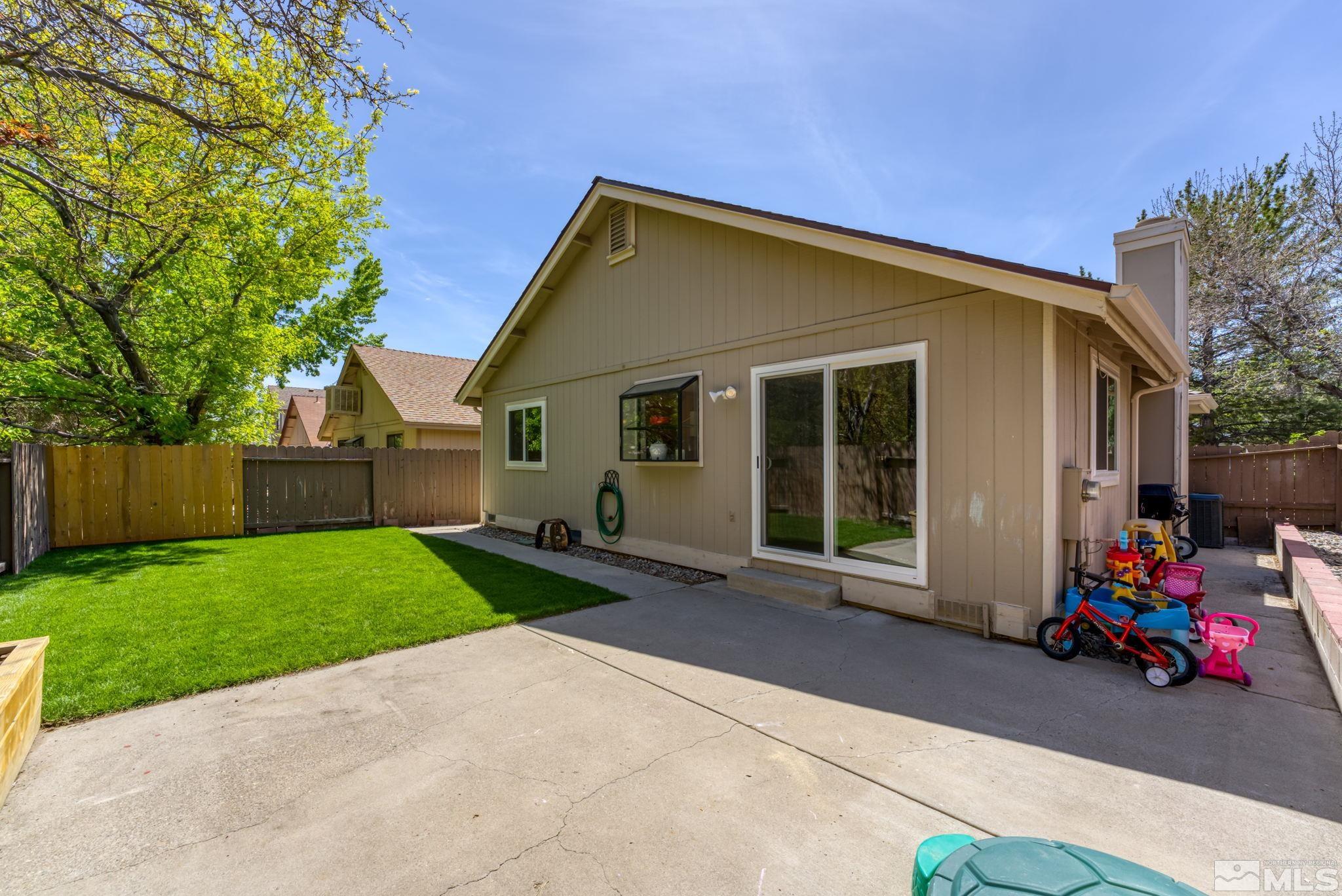 1802 Grand Point Way Reno, NV 89523 - Photo 18 of 19 a view of a house with a small yard and a large tree
