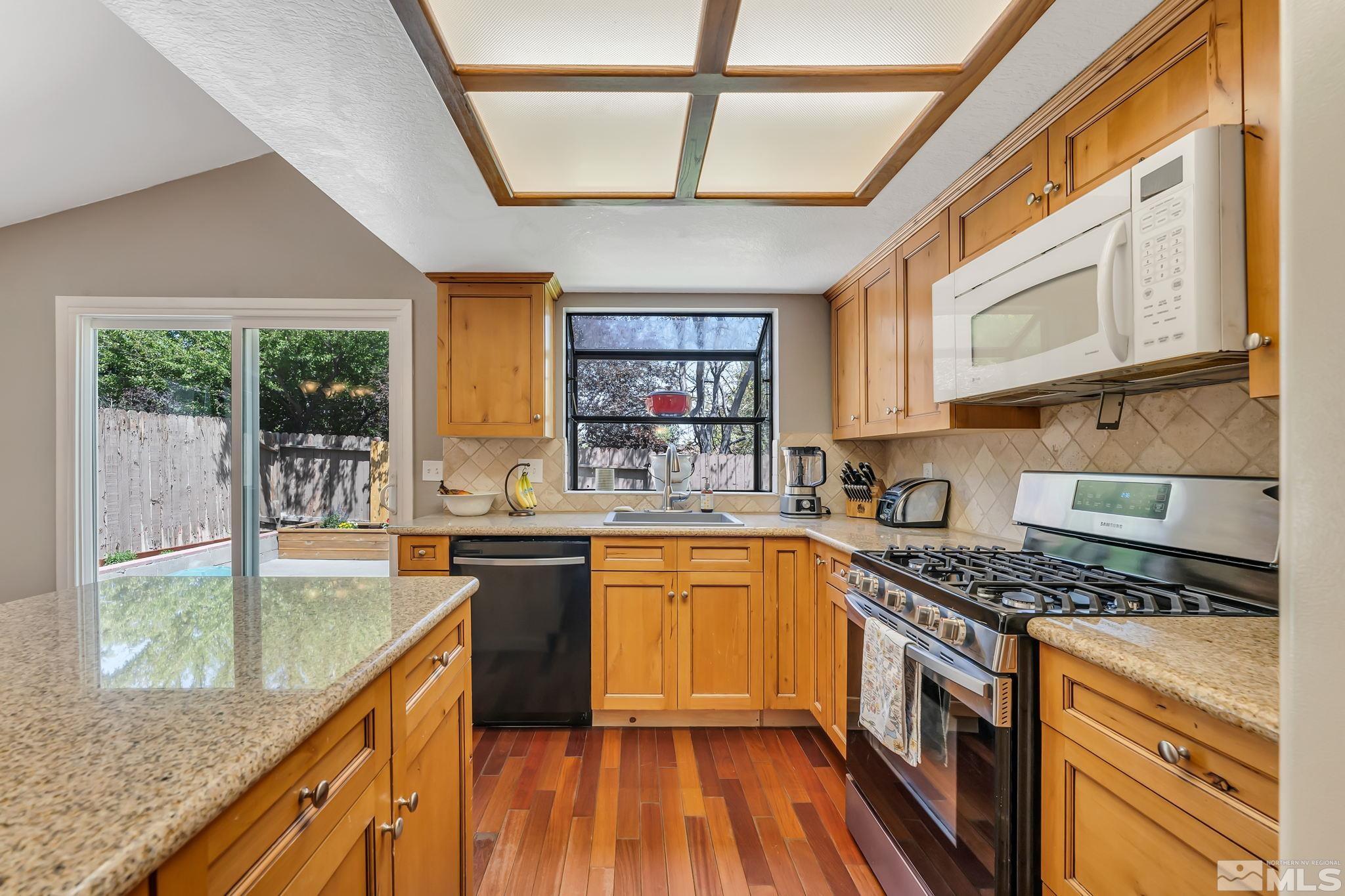 1802 Grand Point Way Reno, NV 89523 - Photo 8 of 19 a kitchen with stainless steel appliances granite countertop a stove and a sink