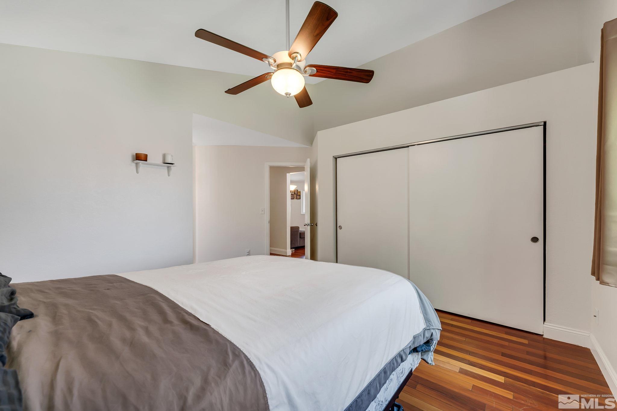1802 Grand Point Way Reno, NV 89523 - Photo 10 of 19 a bedroom with a large bed and a chandelier