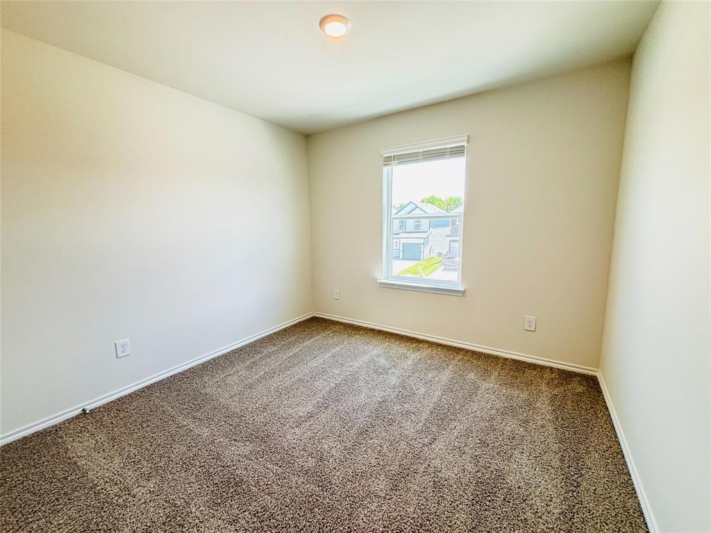 120 Redwood Road Princeton, TX 75407 - Photo 19 of 24 Neutral-toned walls and carpet flooring