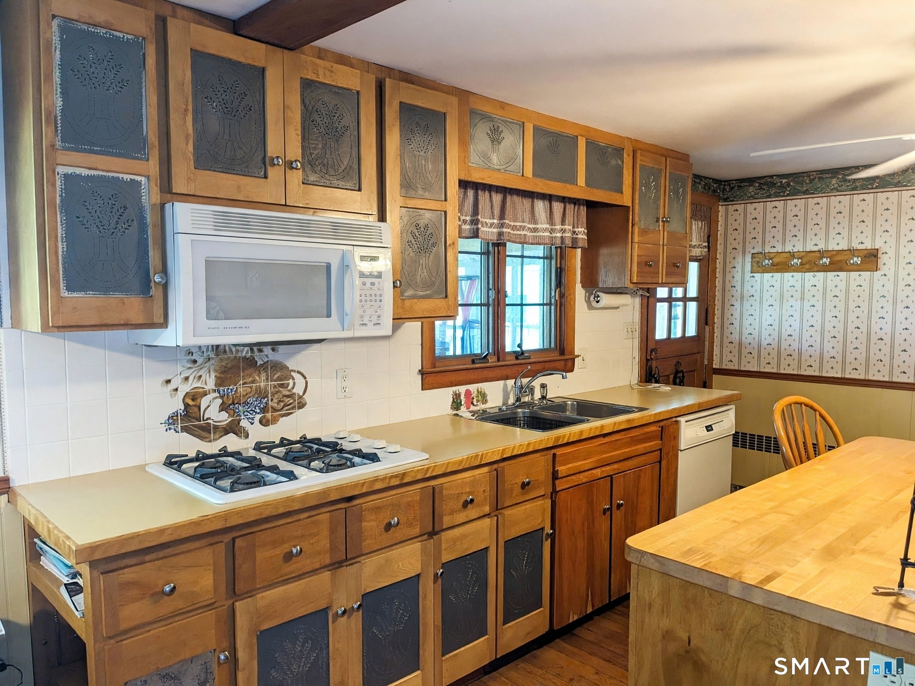 118 River Road Madison, CT 06443 - Photo 18 of 38 Lovely maple cabinets and gas cooktop. Windows and door lead to 3 Season Sunroom.