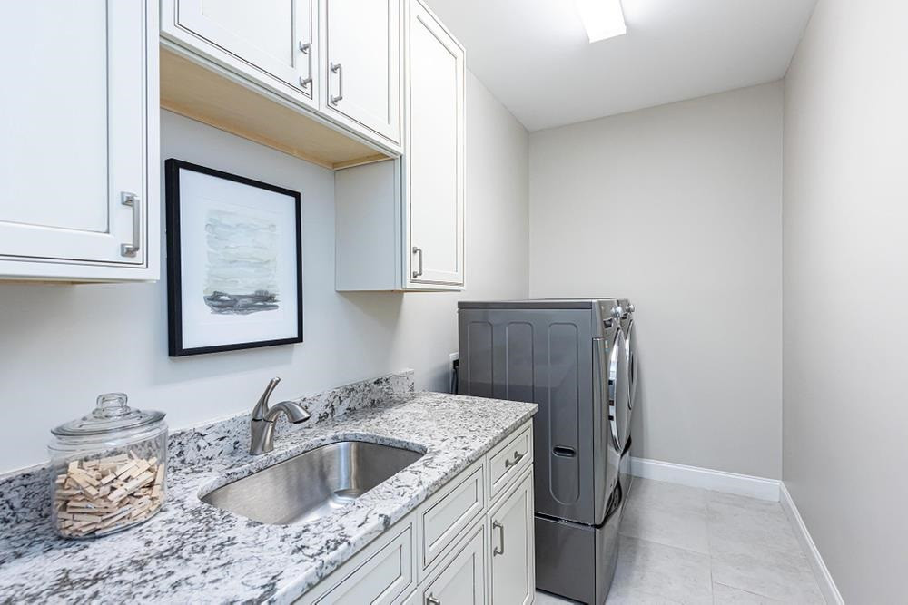 714 Edmund Street Raleigh, NC 27604 - Photo 23 of 30 Second floor Laundry Room with lots of stroage, sink, and lots of walking space.