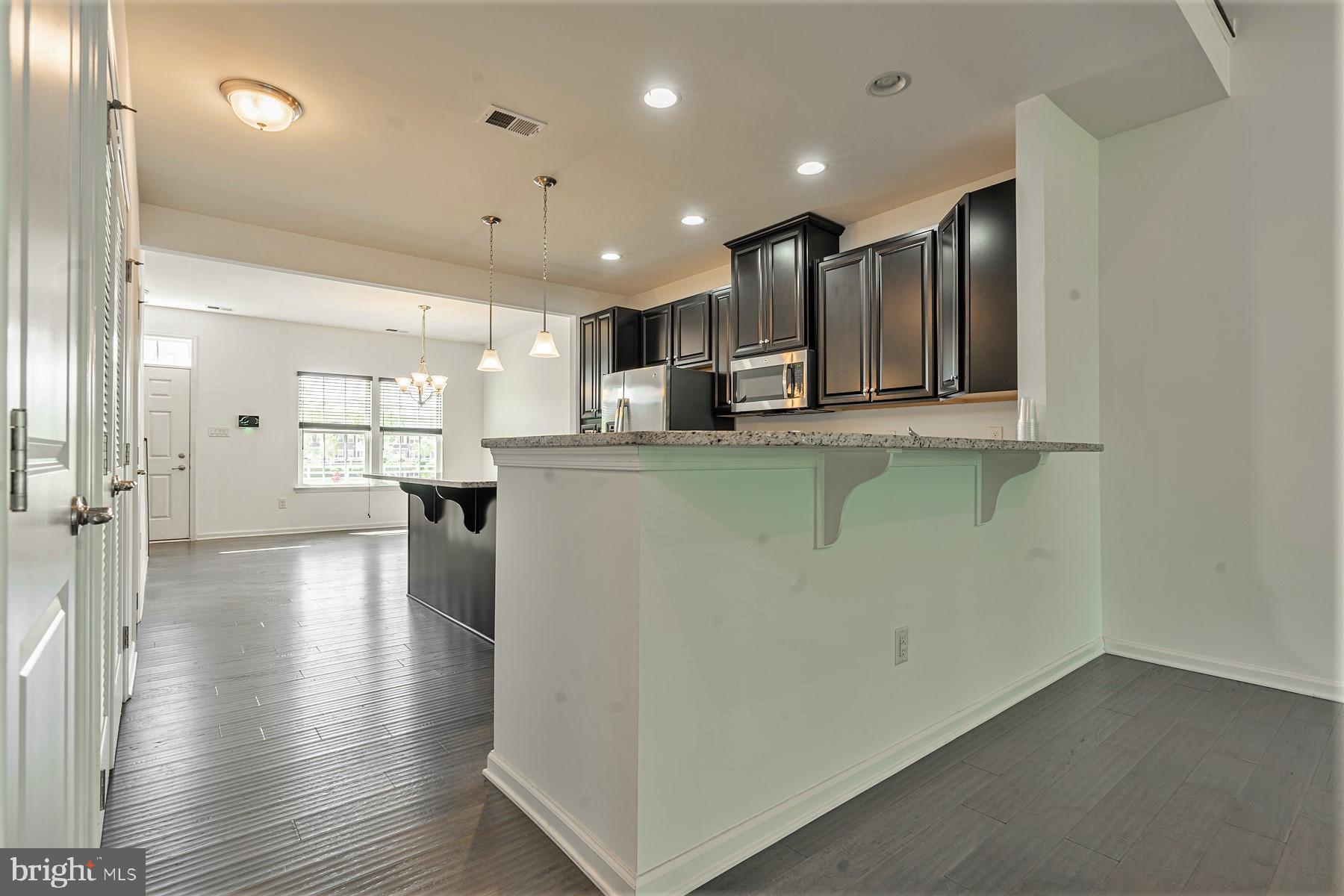 48 Heals Farm Road Burlington, NJ 08016 - Photo 28 of 59 From Living room bar granite area to kitchen