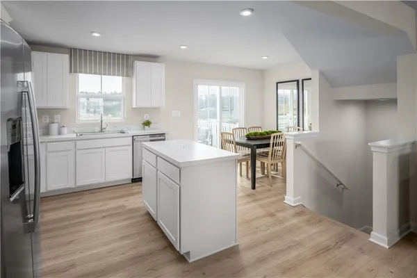 a kitchen with a sink stove and cabinets