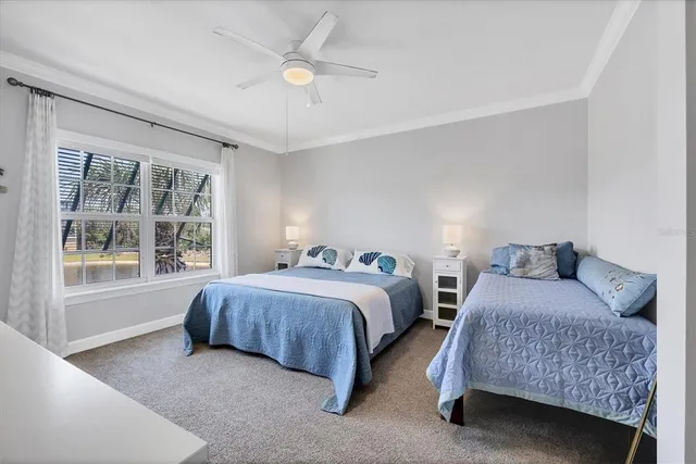 a bedroom with two beds and a large window