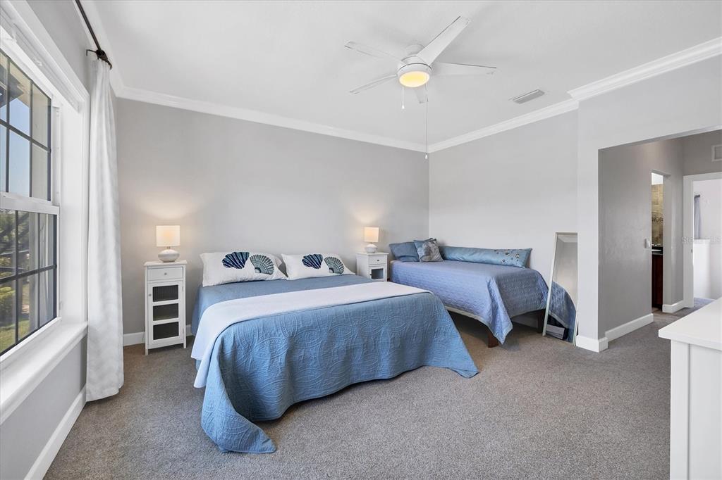 10720 Lemon Creek Loop, Unit 103 Englewood, FL 34224 - Photo 18 of 50 a spacious bedroom with two beds and large windows