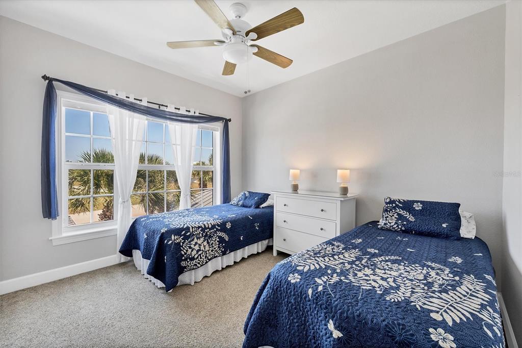 10720 Lemon Creek Loop, Unit 103 Englewood, FL 34224 - Photo 21 of 50 a bedroom with two beds and a large window