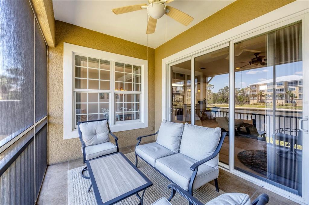 10720 Lemon Creek Loop, Unit 103 Englewood, FL 34224 - Photo 28 of 50 a balcony with furniture and a potted plant
