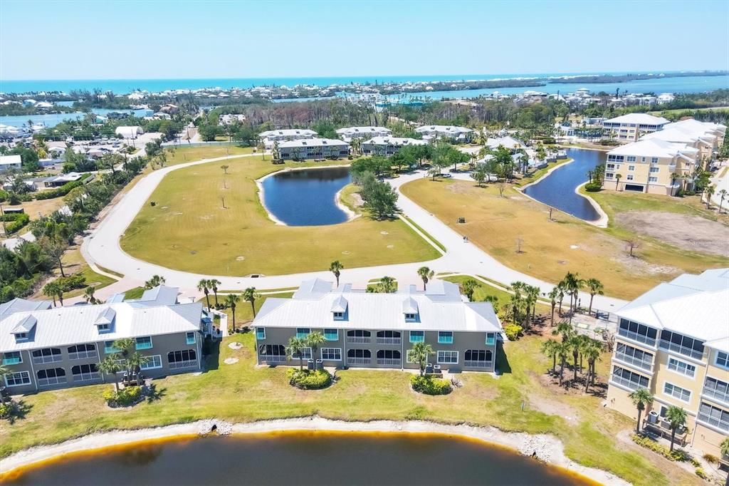 10720 Lemon Creek Loop, Unit 103 Englewood, FL 34224 - Photo 35 of 50 an aerial view of residential houses with outdoor space