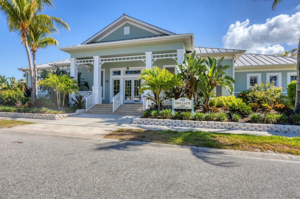 10720 Lemon Creek Loop, Unit 103 Englewood, FL 34224 - Photo 38 of 50 a view of a house with a swimming pool and a yard with potted plants