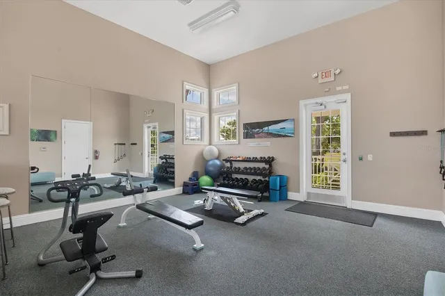 a room with gym equipment and large window
