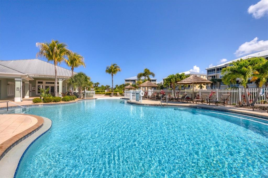 10720 Lemon Creek Loop, Unit 103 Englewood, FL 34224 - Photo 43 of 50 a swimming pool with outdoor seating and yard