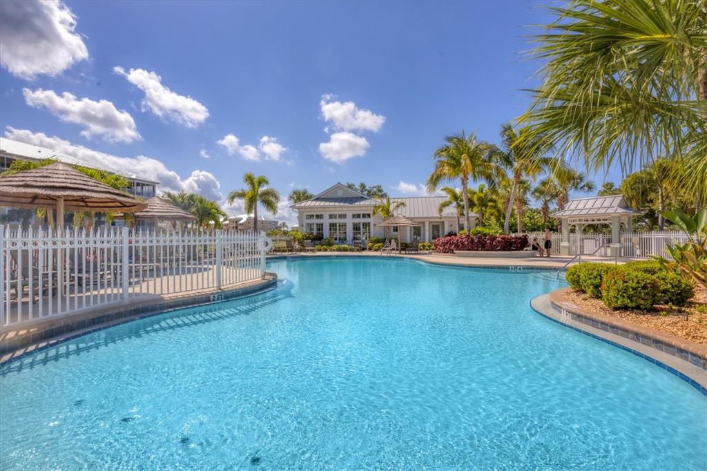 10720 Lemon Creek Loop, Unit 103 Englewood, FL 34224 - Photo 45 of 50 a view of a house with a swimming pool and a yard