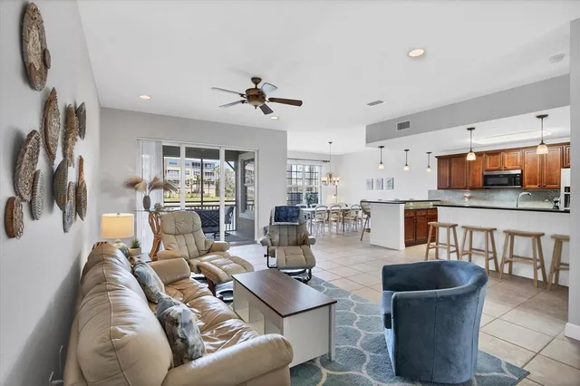 a living room with furniture and a view of kitchen