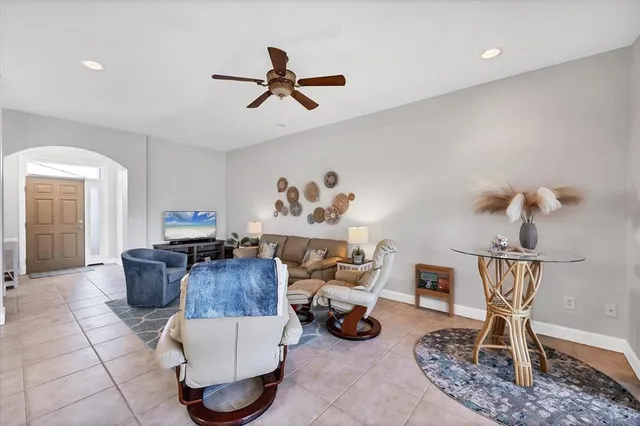 a living room with furniture and a chandelier