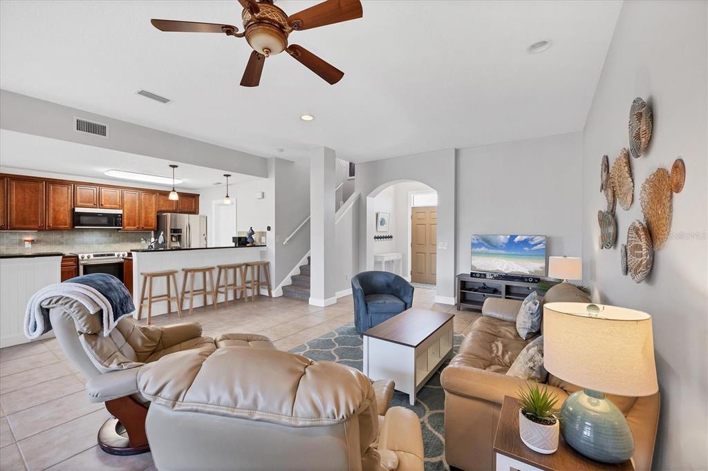 10720 Lemon Creek Loop, Unit 103 Englewood, FL 34224 - Photo 9 of 50 a living room with furniture and a view of kitchen