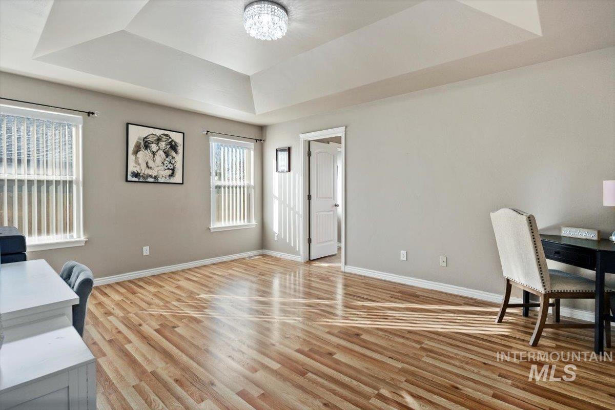 657 Creekside Way Twin Falls, ID 83301 - Photo 20 of 45 Office space with a raised ceiling, a chandelier, and light wood-type flooring