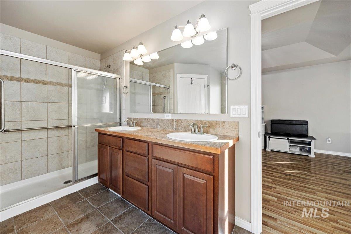 657 Creekside Way Twin Falls, ID 83301 - Photo 24 of 45 Full bath with double vanity and a shower stall