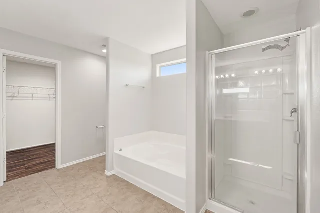 a bathroom with a bathtub and a shower