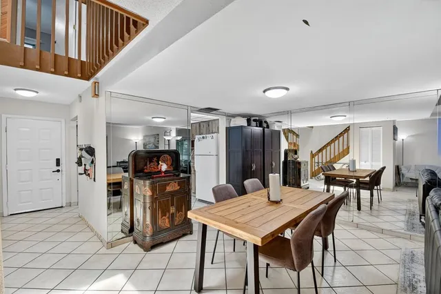 a dining room with furniture and wooden floor