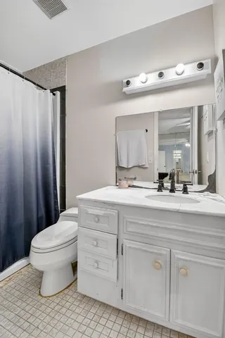 a bedroom with a large bed and a large window