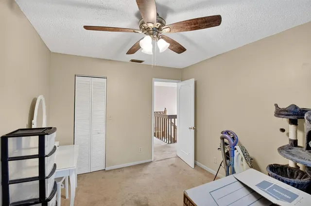 a living room with furniture a flat screen tv and a large window