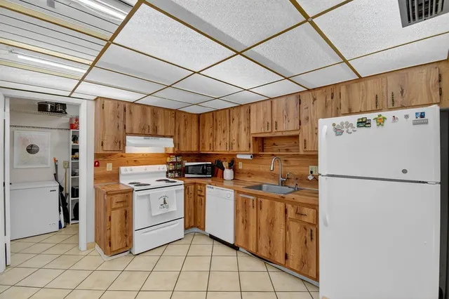 a kitchen with refrigerator and cabinets