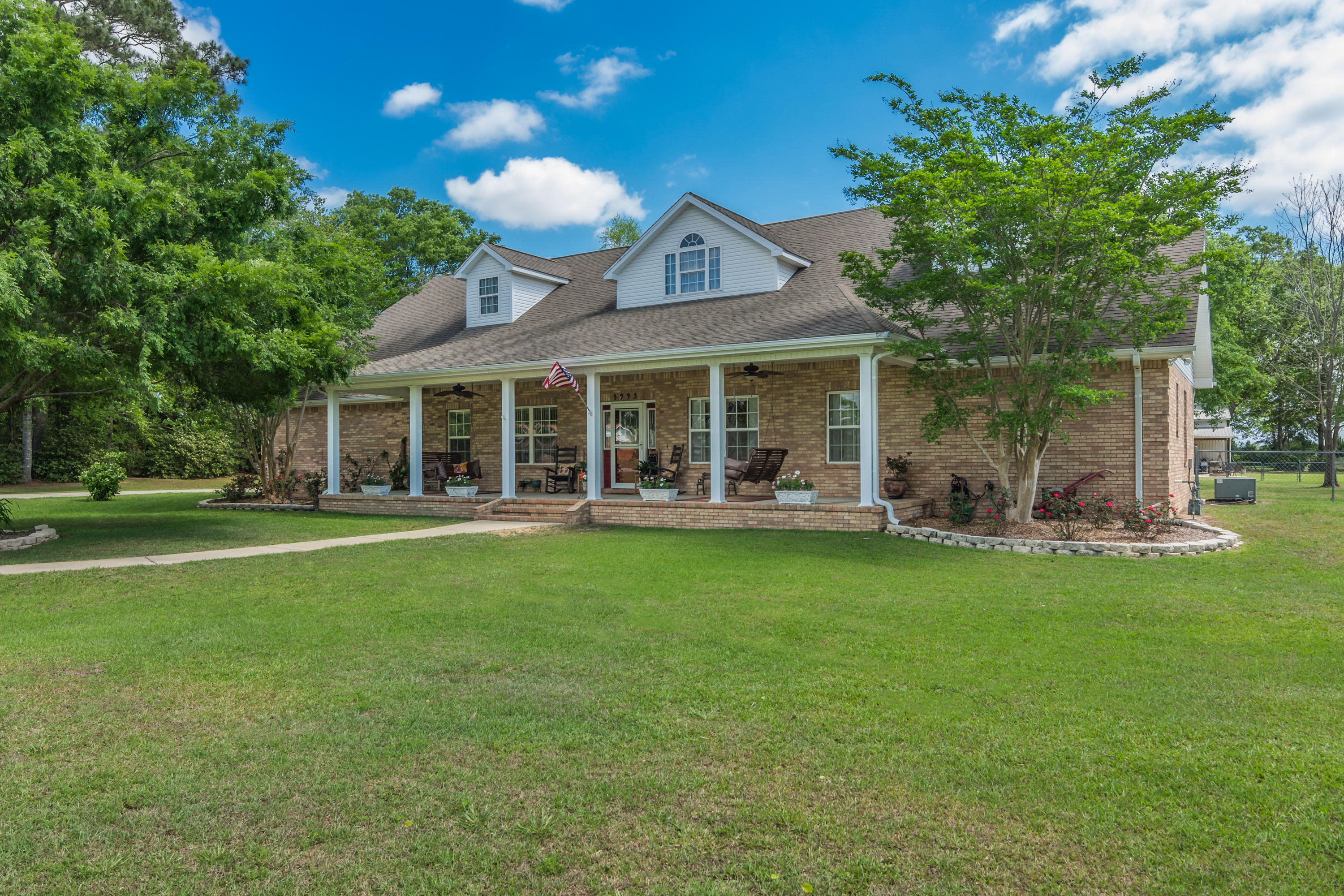 5995 Jack Stokes Road Baker, FL 32531 - Photo 1 of 60 a view of a house with a yard and sitting area